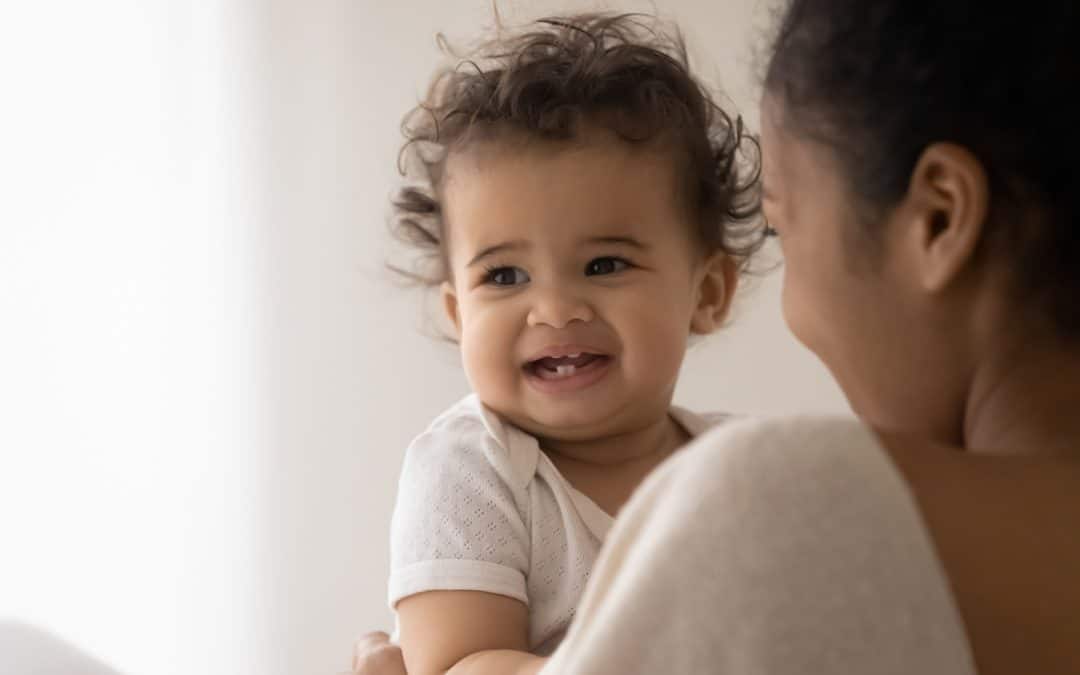 parent with baby booking baby tooth dental appointment at kimball pediatric dentistry