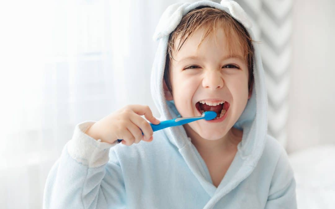 Boy brushes his teeth with floride toothpaste in Brooklyn NY