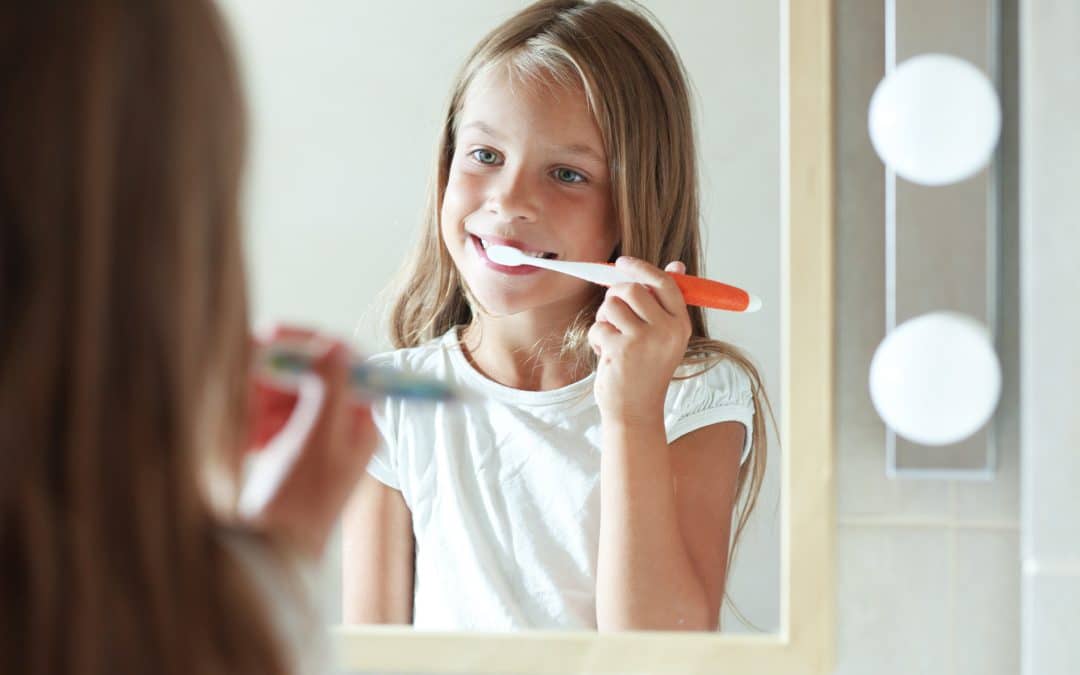 Preteen girl brushing her teeth with fluoride in Brooklyn NY