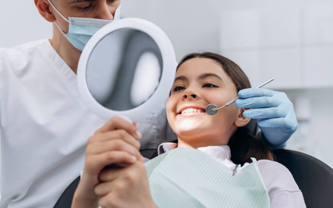 Pre teen girl looks at her smile after tooth decay treatment in Brooklyn NY